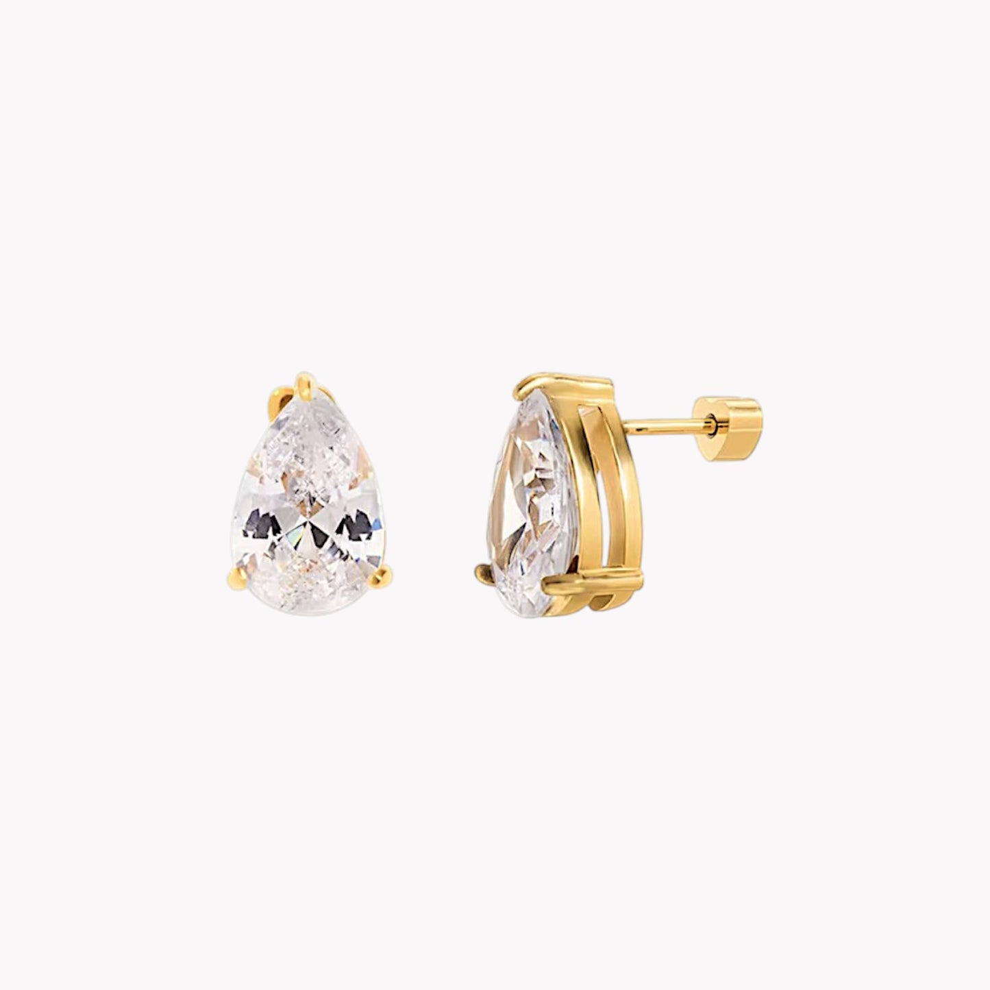 Gold earrings with clear gemstones on a white background