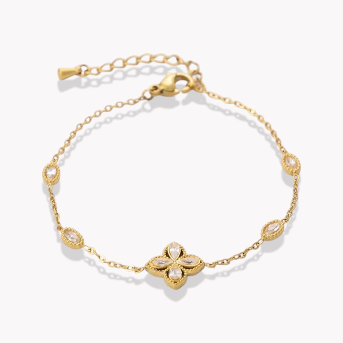 Gold bracelet with a clover-shaped clasp on a white background