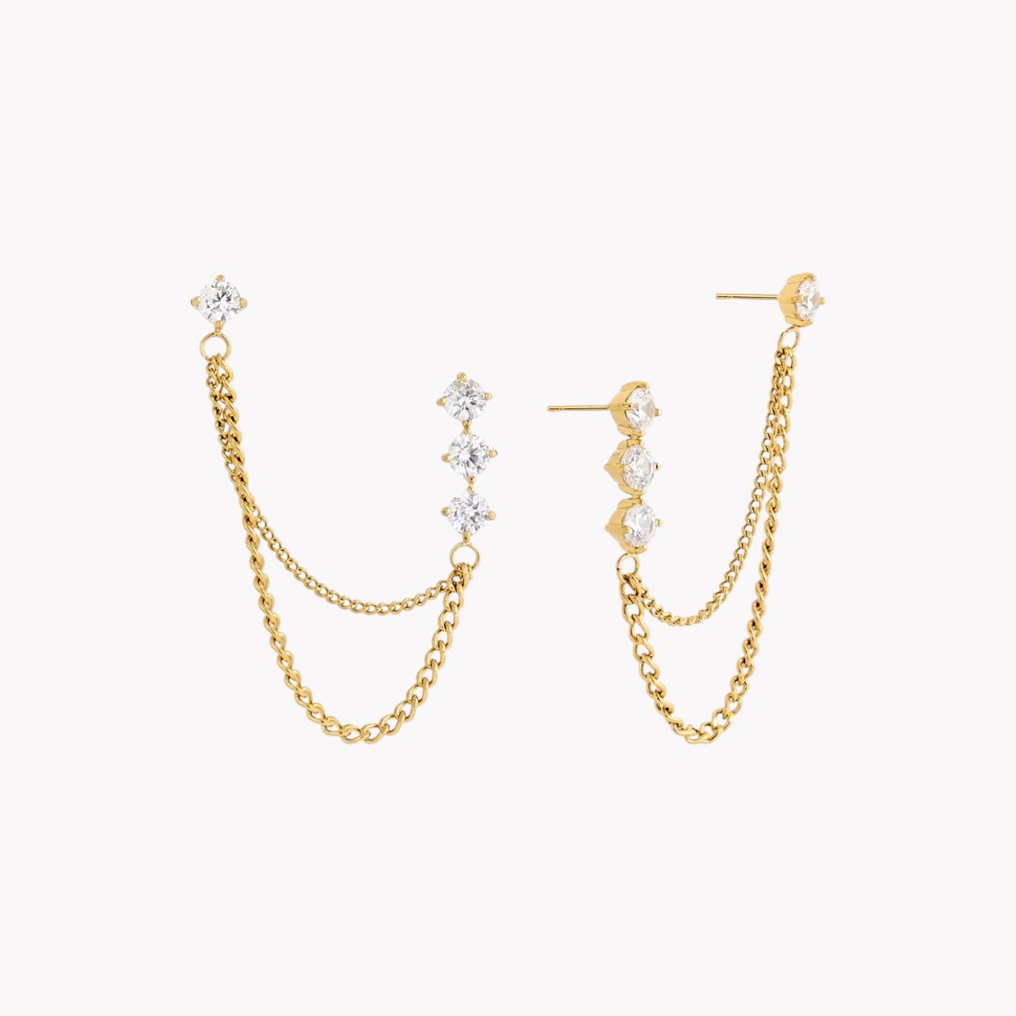 Gold chain earrings with clear gemstones on a white background