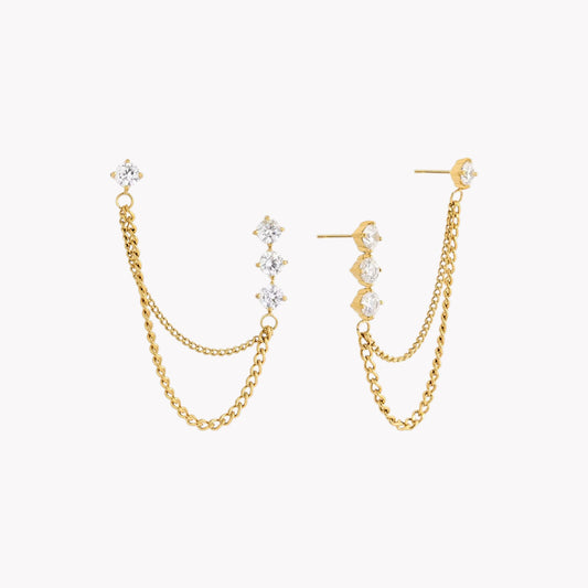 Gold chain earrings with clear gemstones on a white background