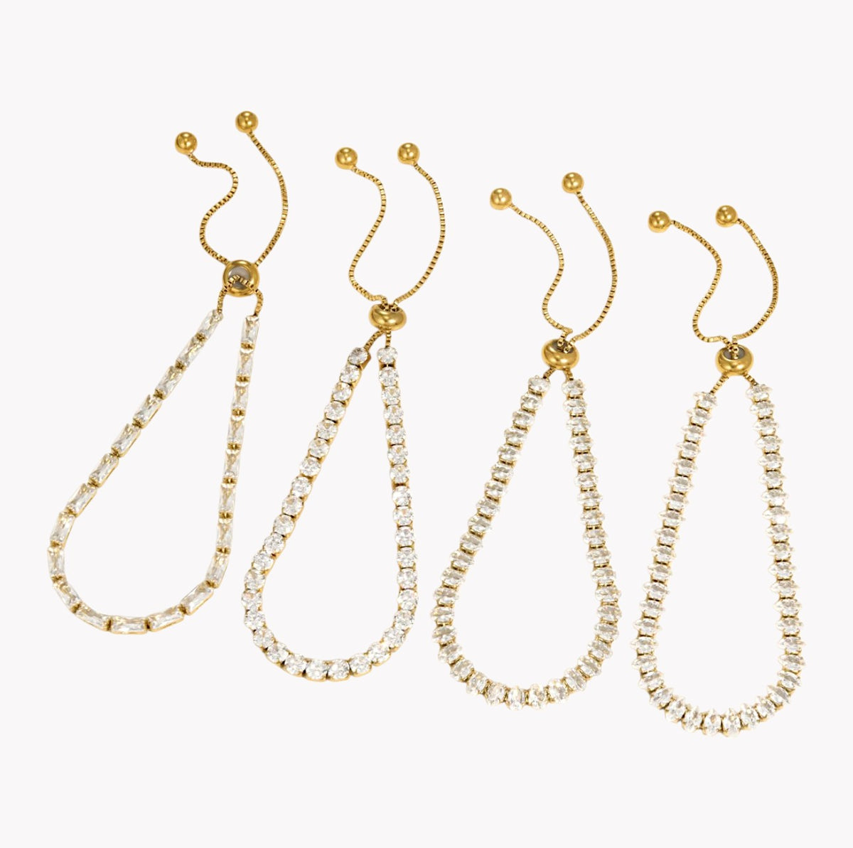 Four gold-tone drop earrings with clear rhinestone-studded teardrop-shaped chains, arranged in a row against a plain white background.