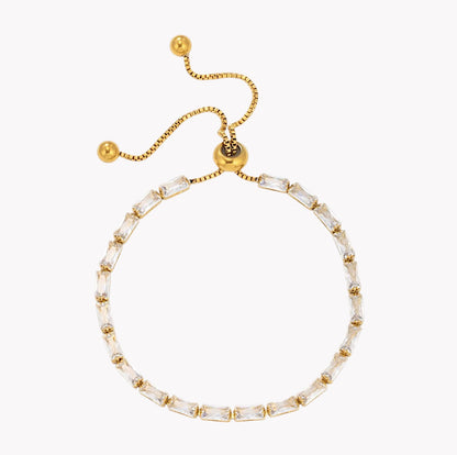 A gold-tone adjustable slide chain bracelet featuring clear baguette-cut crystals, displayed on a clean white background.
