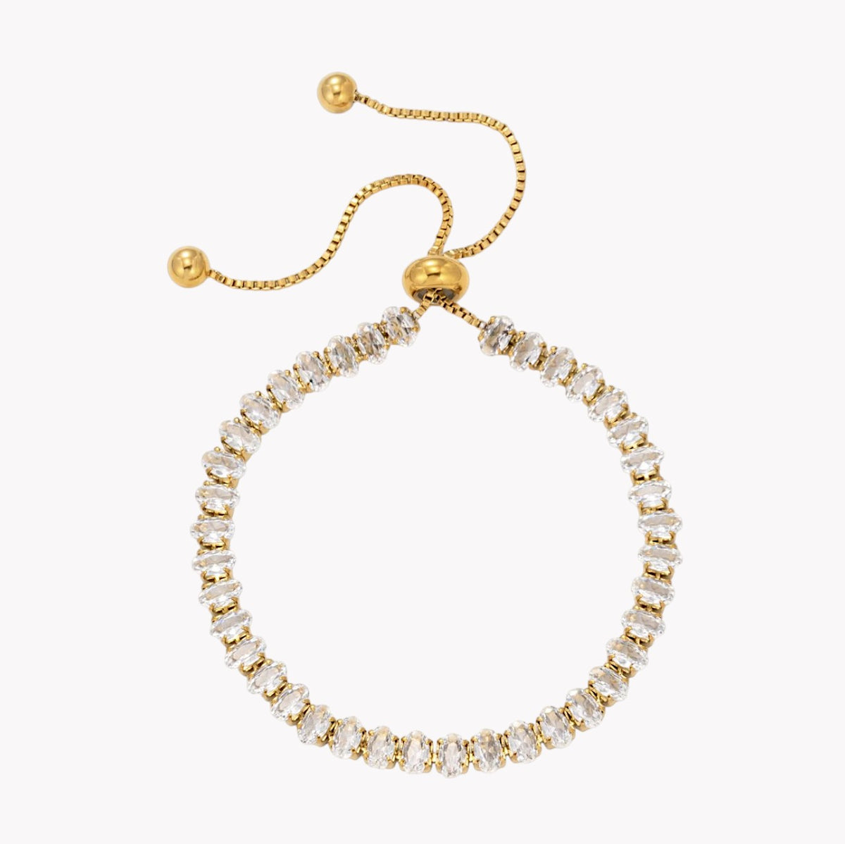 A gold adjustable ring bracelet with a row of clear baguette-cut crystals, shown on a plain white background.