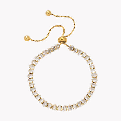 A gold adjustable ring bracelet with a row of clear baguette-cut crystals, shown on a plain white background.