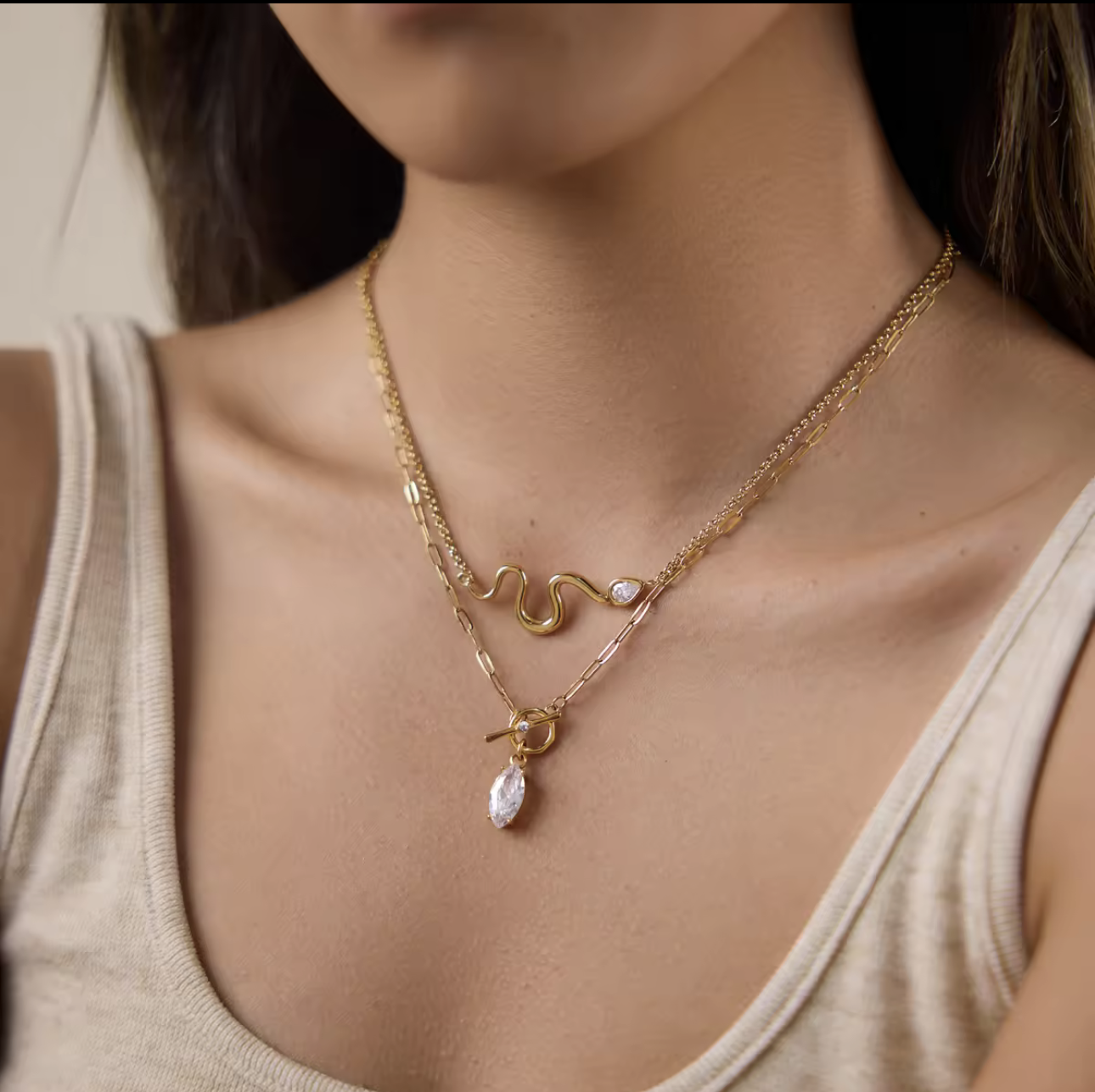 gold necklace with marquise gemstone pendant pictured being worn