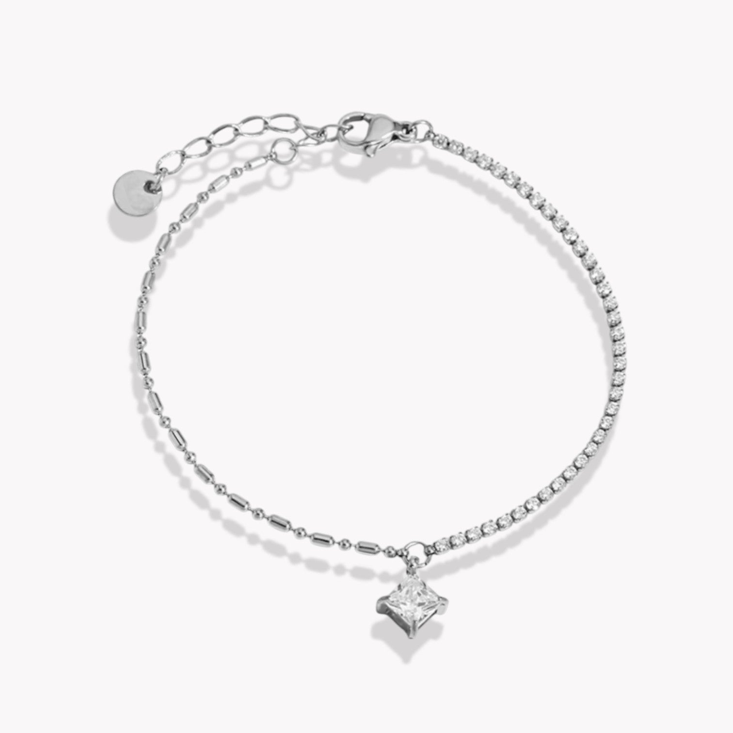Silver bracelet with a princess cut gemstone on a white background
