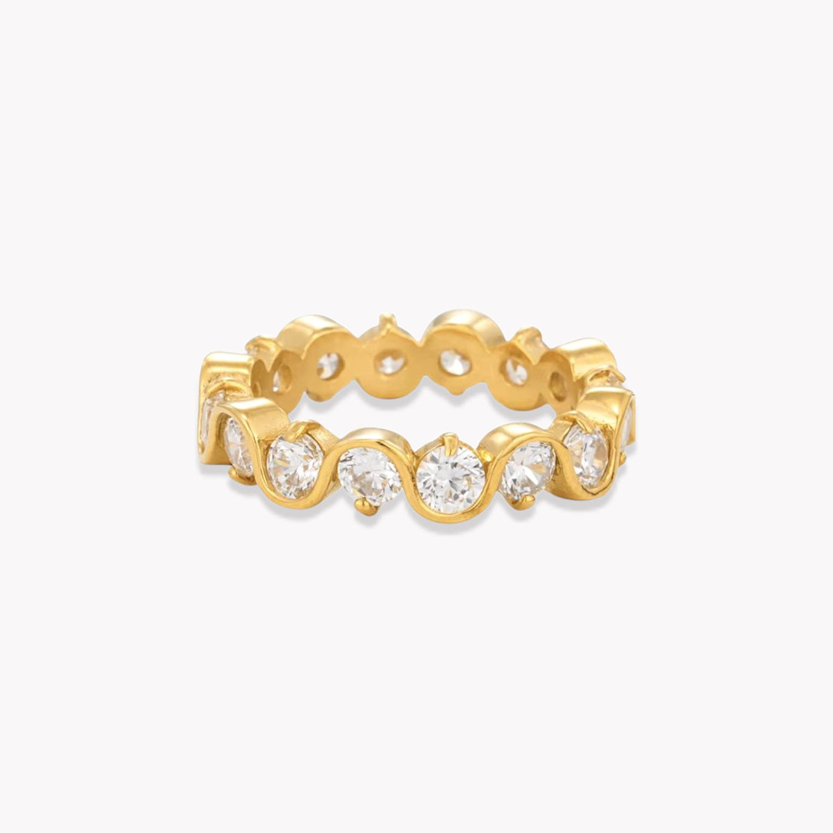 A yellow gold eternity ring featuring a continuous row of round-cut clear gemstones in a bezel setting, shown on a clean white background.