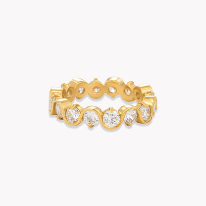 A yellow gold eternity ring featuring a continuous row of round-cut clear gemstones in a bezel setting, shown on a clean white background.