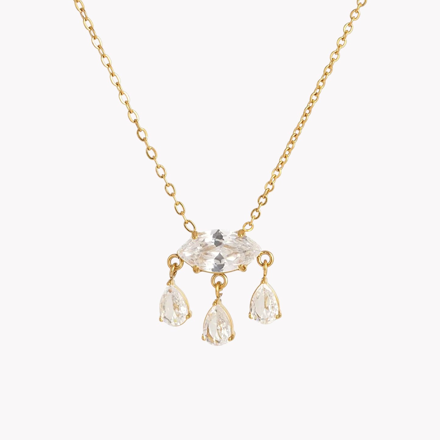 Gold necklace with clear crystal pendants on a white background