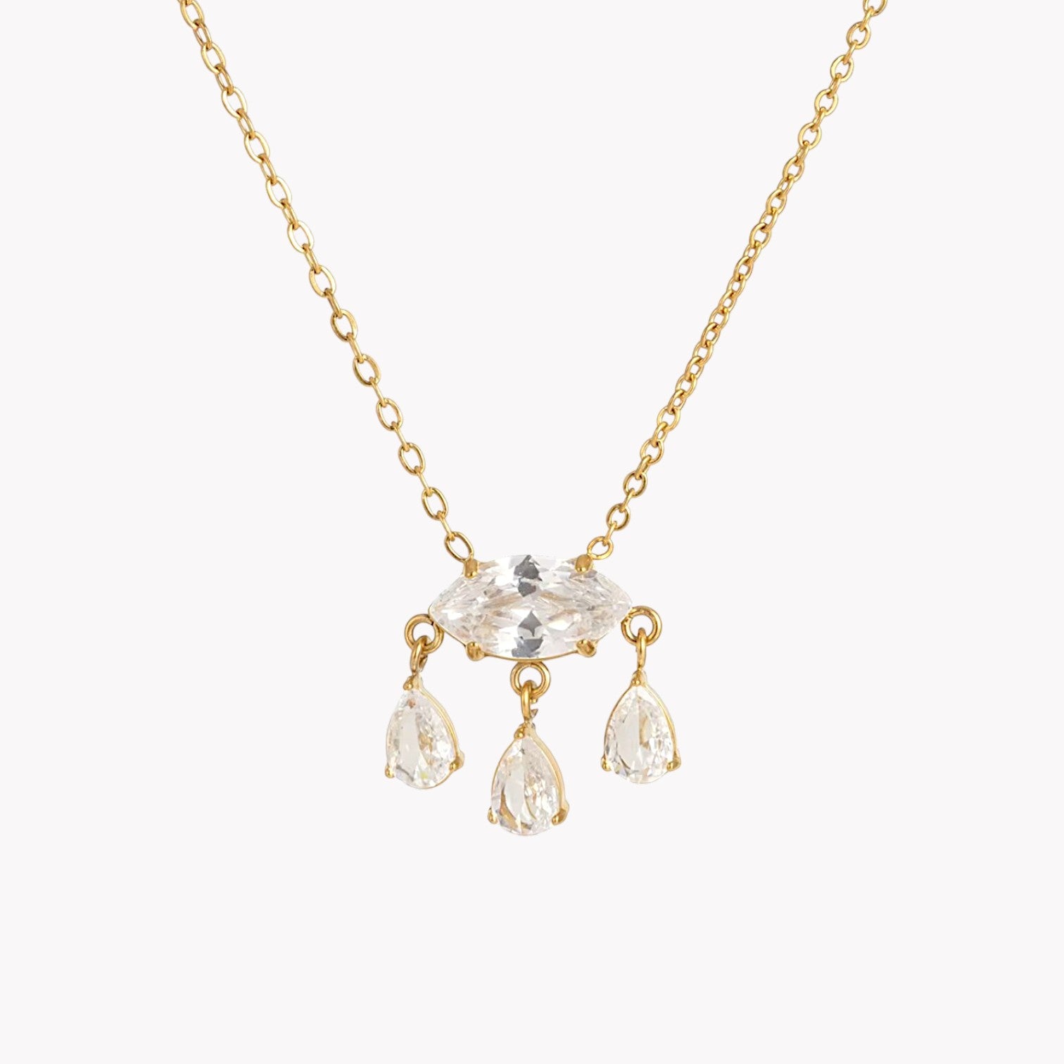 Gold necklace with clear crystal pendants on a white background