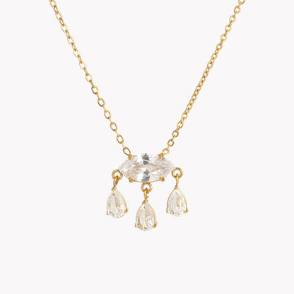 Gold necklace with clear crystal pendants on a white background