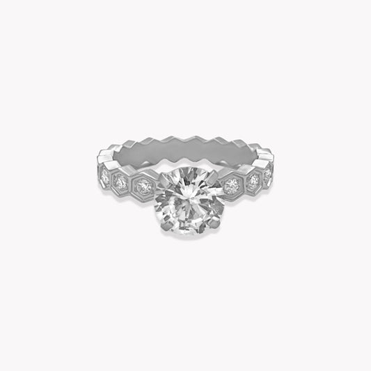 Diamond ring with hexagonal band on a white background