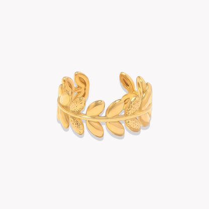 An 18k gold ring with leaf sculpted details around the band, displayed on a white background.