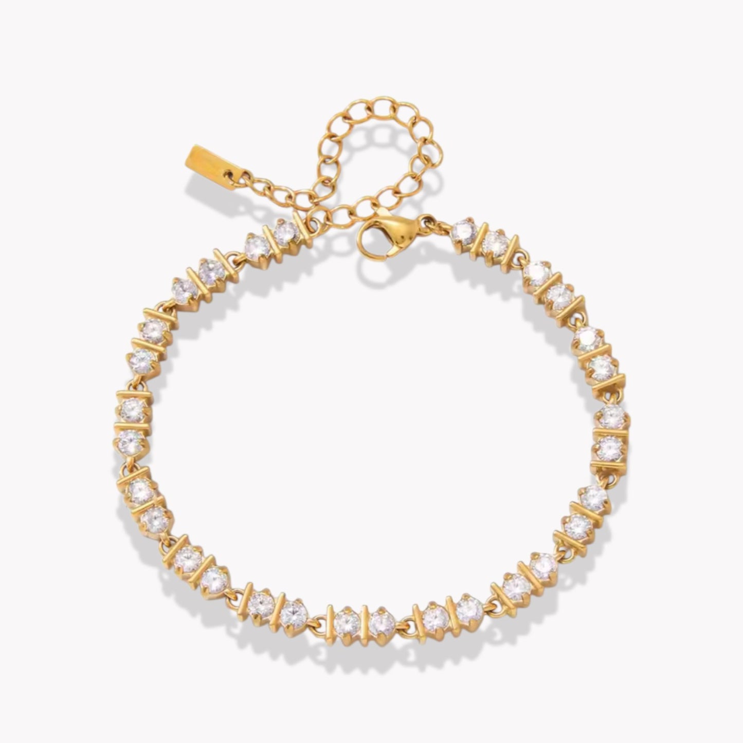 Gold bracelet with clear stones on a white background