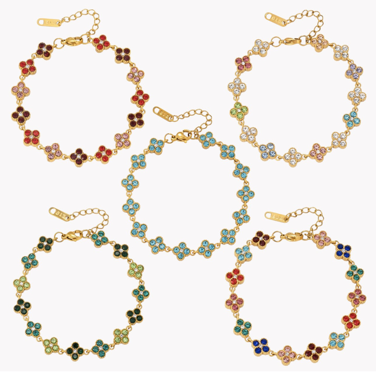 Five gold-tone floral link bracelets with colorful enamel clover motifs, arranged on a plain white background.
