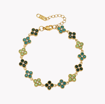 A gold-plated bracelet featuring alternating four-leaf clover motifs in light green and dark green, with a gold clasp and extender chain, shown on a plain white background.