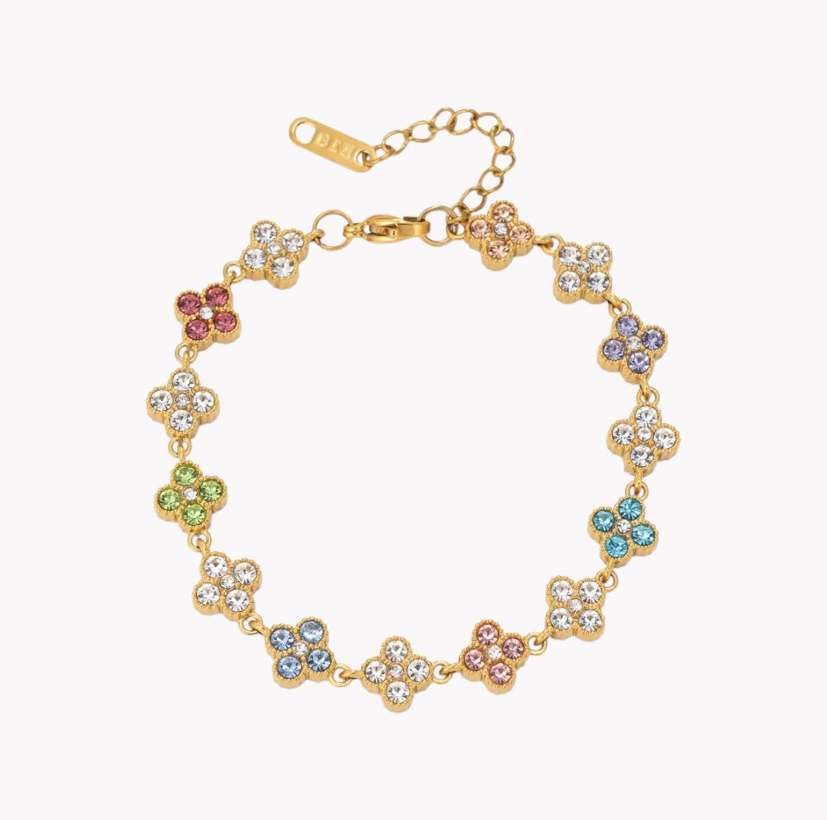 A gold-plated flower bracelet with clear rhinestones and small multicolor accent stones, shown on a light gray background.