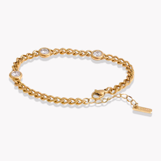 Gold chain bracelet with 3 embedded stones on a white background