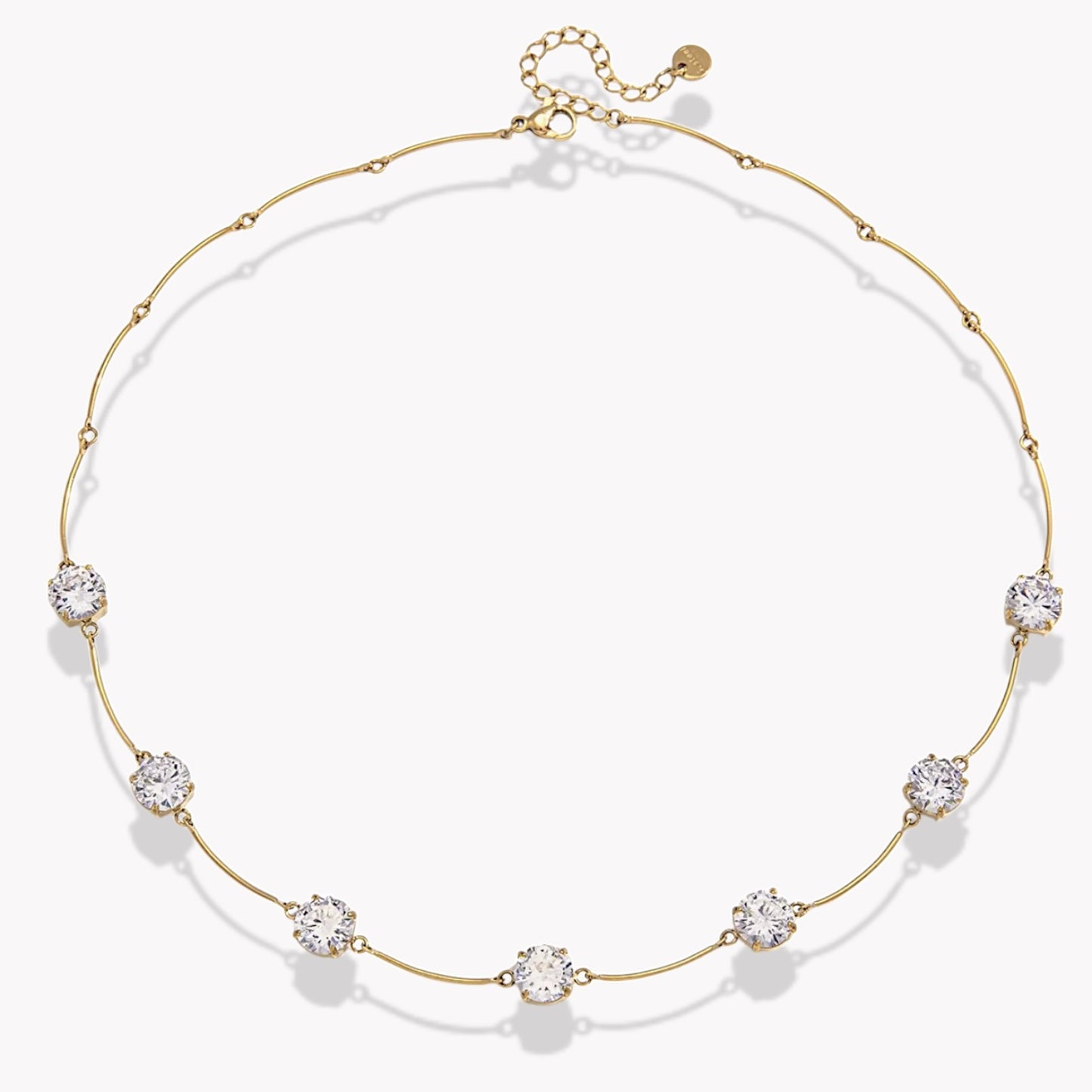 gold necklace with 7 beautiful gemstones on light grey background