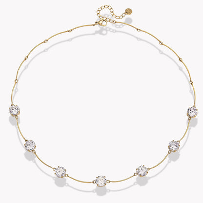 gold necklace with 7 beautiful gemstones on light grey background