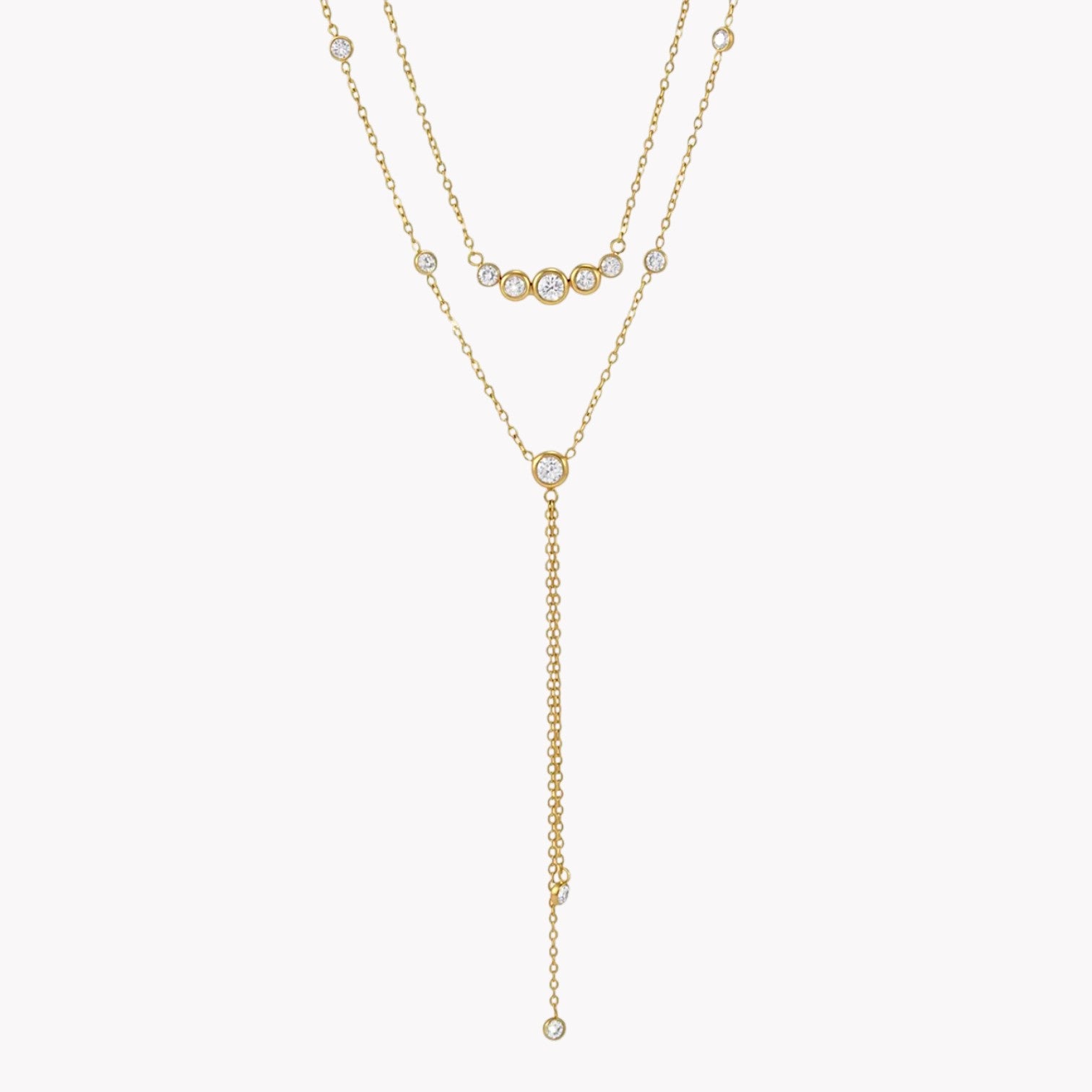 gold double layered necklace with clear gemstones pictured on a light grey background
