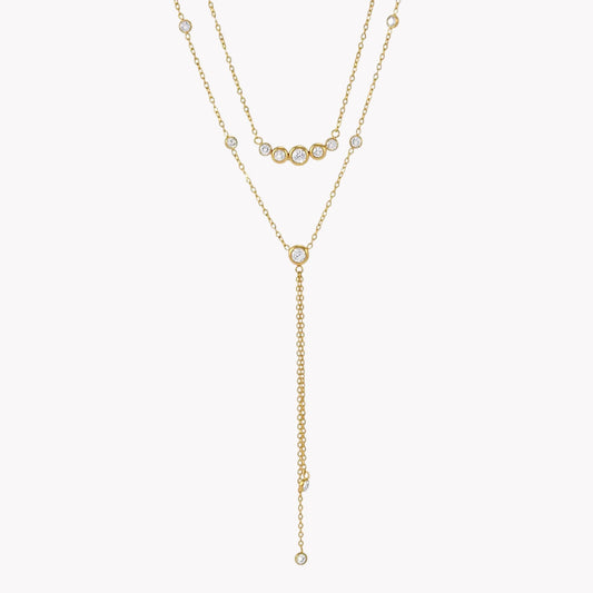 gold double layered necklace with clear gemstones pictured on a light grey background