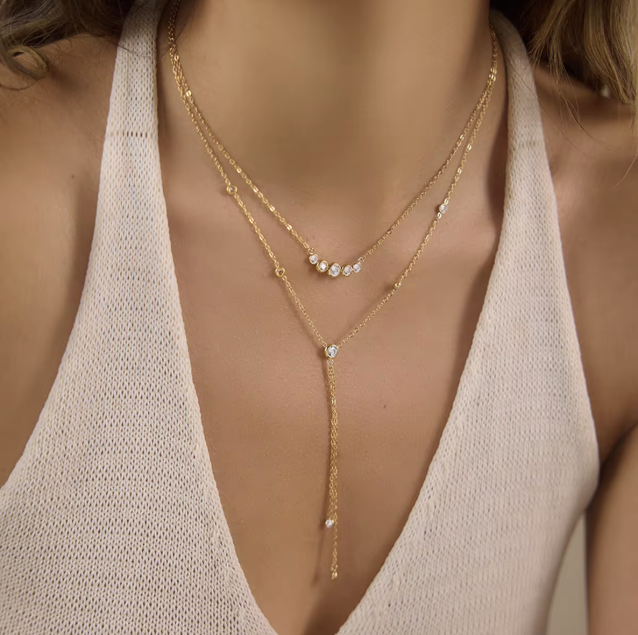 gold double layered necklace with clear gemstones pictured being worn