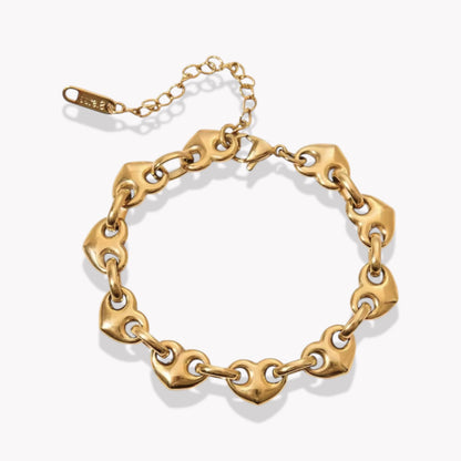 Gold chunky chain bracelet with heart chaped links on a white background