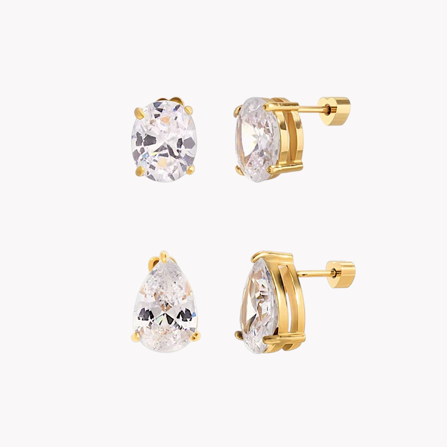 Gold earrings with clear gemstones on a white background