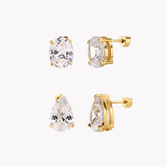 Gold earrings with clear gemstones on a white background