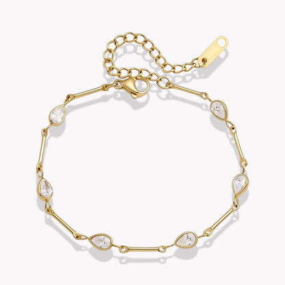 A gold chain bracelet with eight teardrop-shaped clear crystals spaced along the link chain, shown on a clean white background.