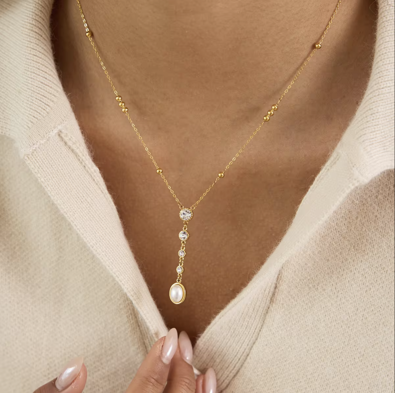 close up of gold necklaces being worn around a neck