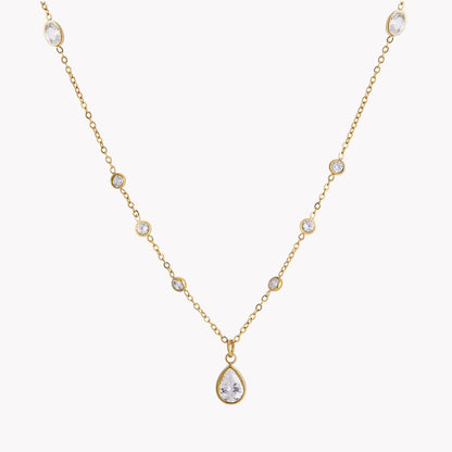 Gold necklace with a teardrop-shaped pendant on a white background