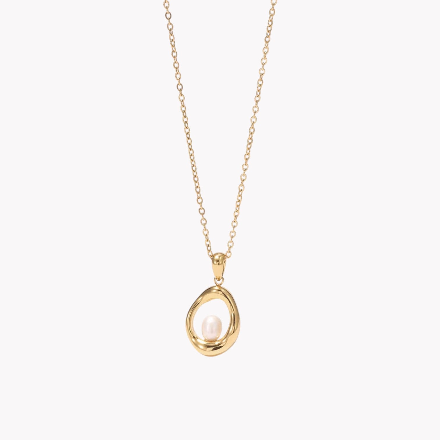 gold necklace with circular pendant featuring a small pearl inside