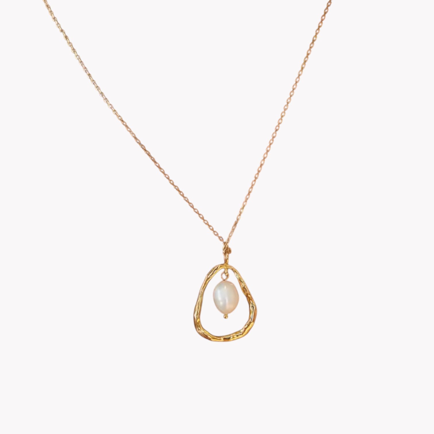 Gold necklace with a teardrop-shaped pendant featuring a pearl on a white background