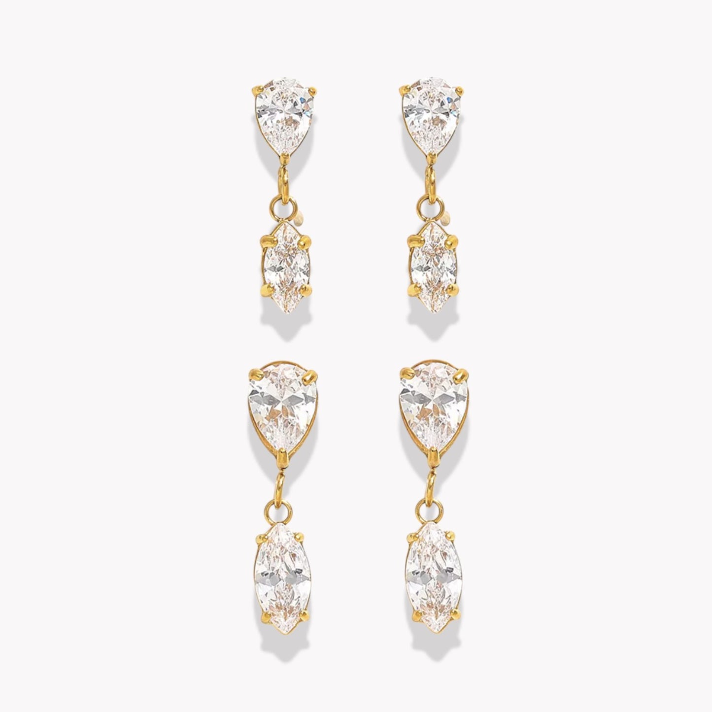Gold and crystal drop earrings on a white background