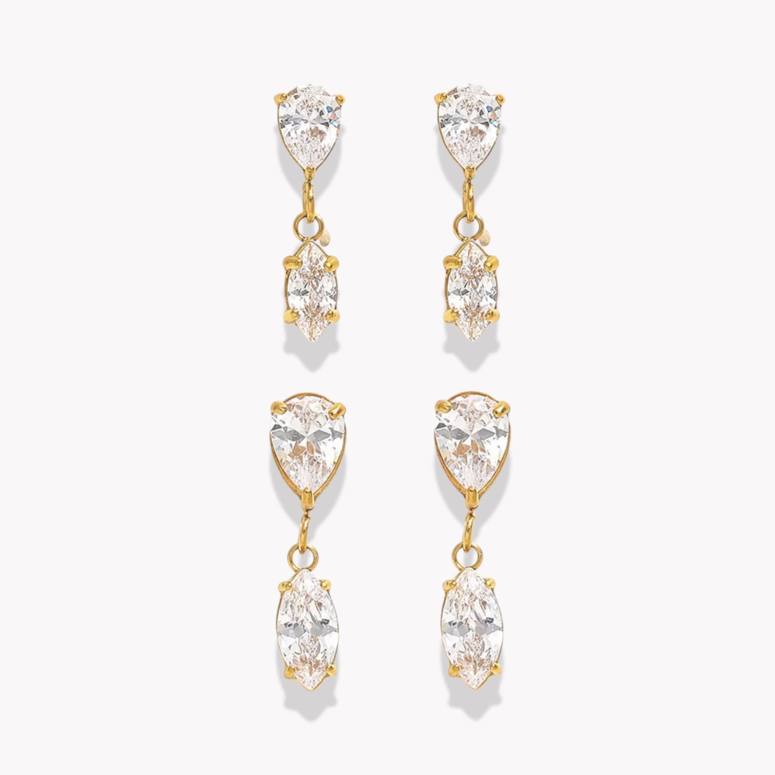 Gold and crystal drop earrings on a white background