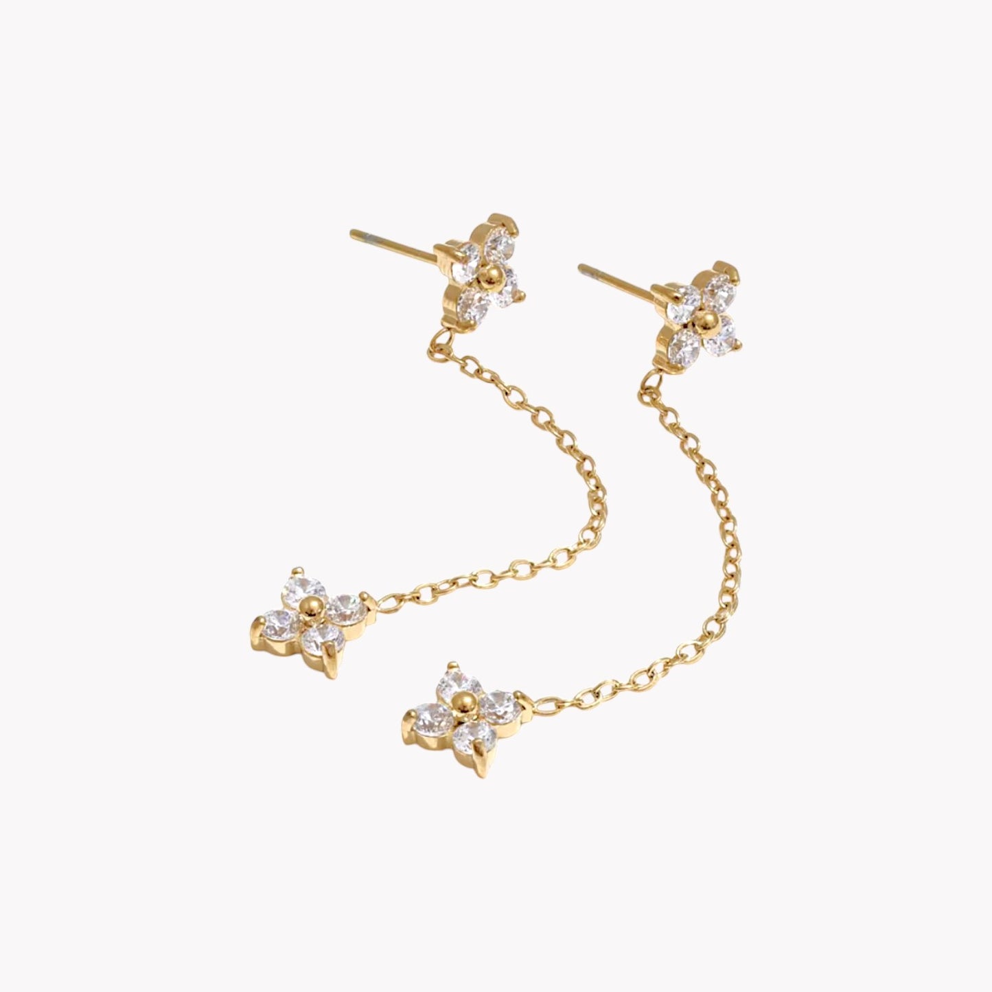 flower shapes gemstone on a long earring stud on a light grey background