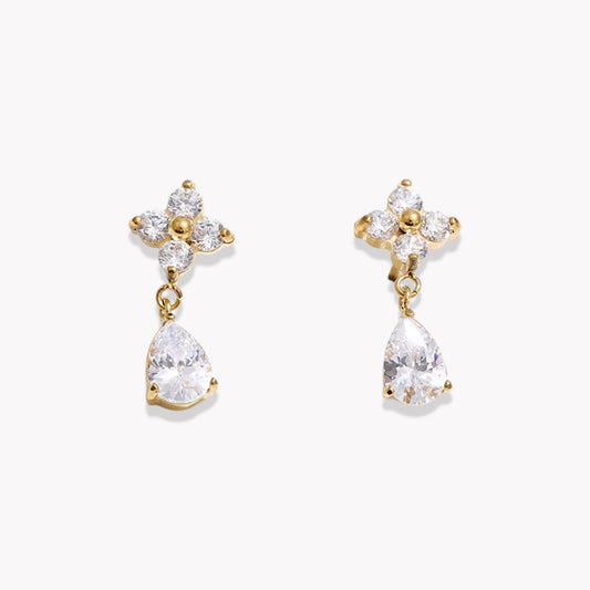 Gold earrings with teardrop-shaped crystals on a white background