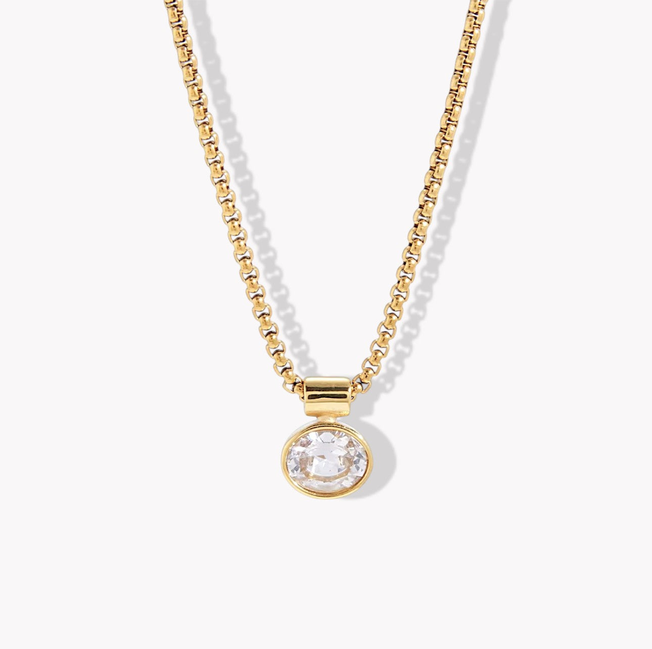 Necklace with gold chain and round crystal pendant on a white background