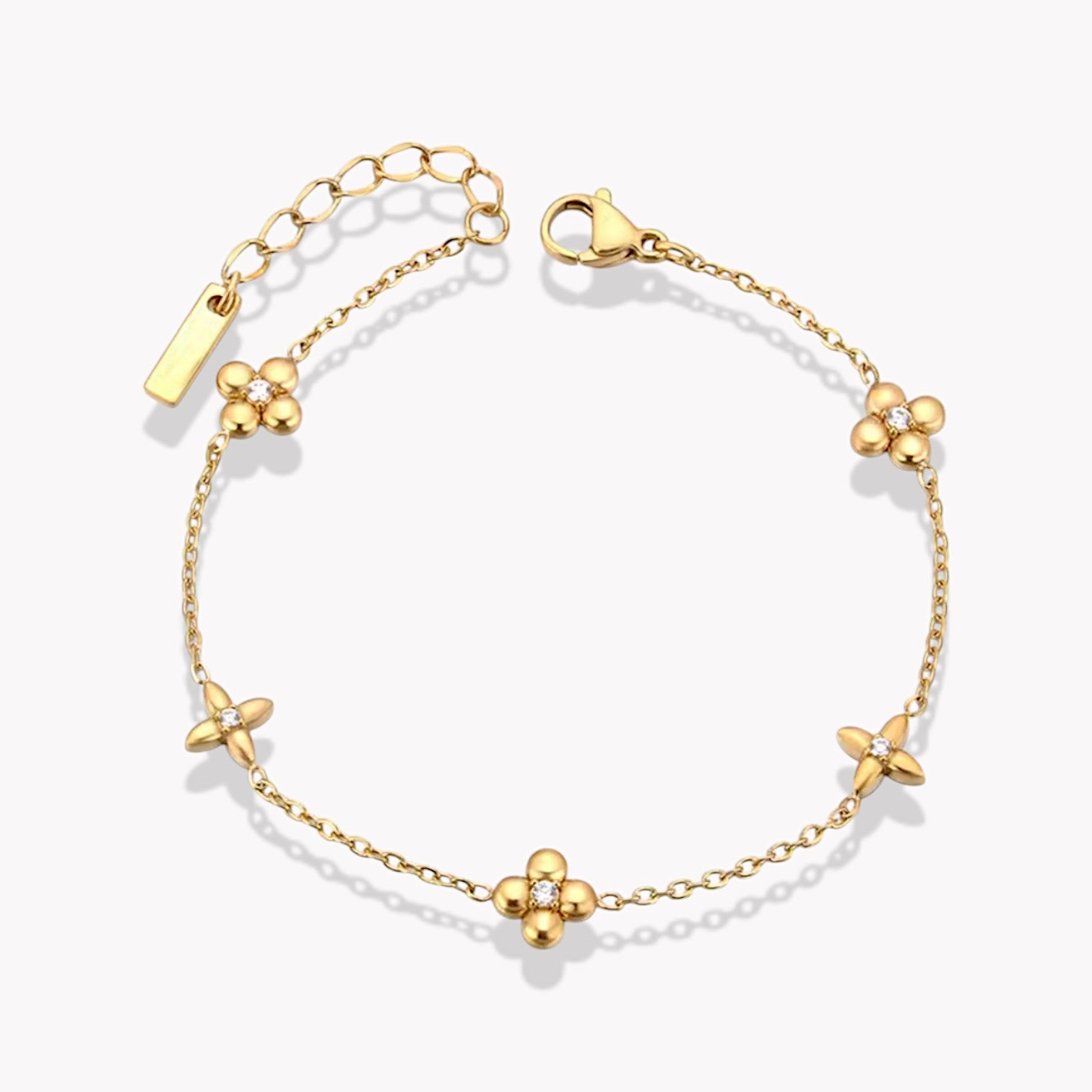 A gold-plated stainless steel bracelet with flower details, featuring a extender chain and a secure clasp.