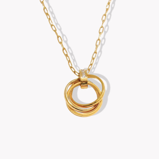 Gold necklace with interlocking rings and tiny clear gemstone detail on a white background