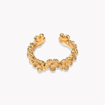 An adjustable gold ring with a floral pattern around the band, displayed against a white background.