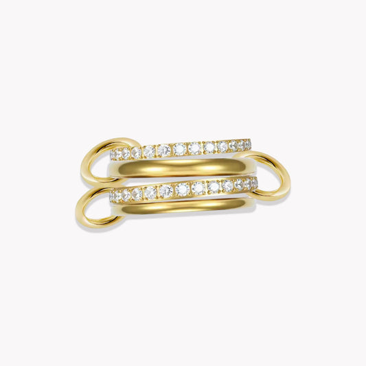 Gold layered link ring, featuring 4 bands - two plain silver and 2 with clear gemstones. Held together by three smaller links pictured on a white background