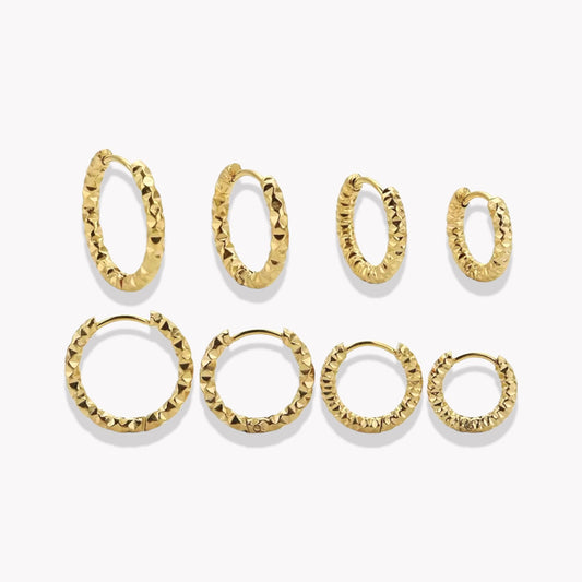 A collection of Lexi Hooped Earrings in various sizes, made of stainless steel with 18K gold plating, displayed against a white background.