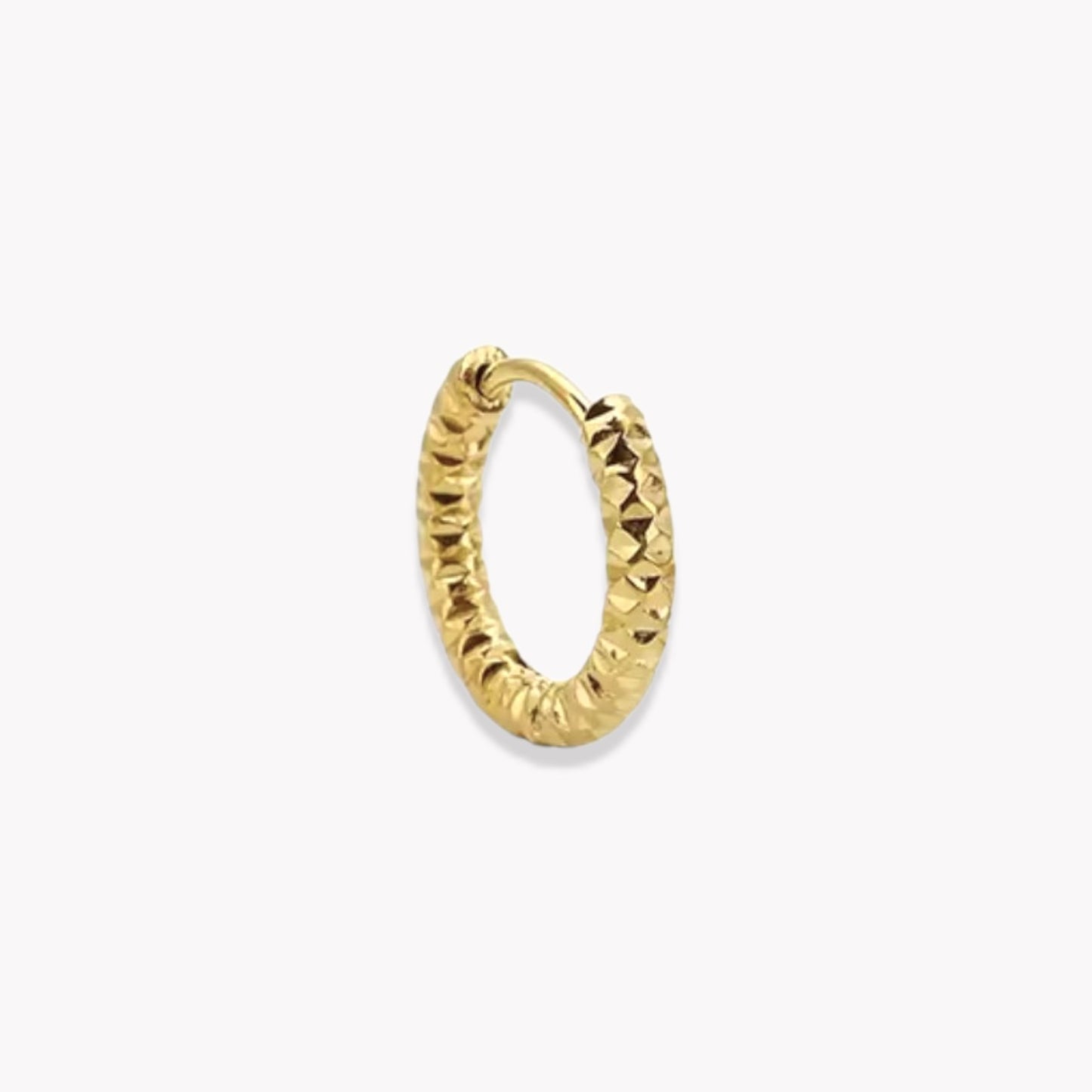 Gold hooped earring being shown in a closed position, pictured on a white background