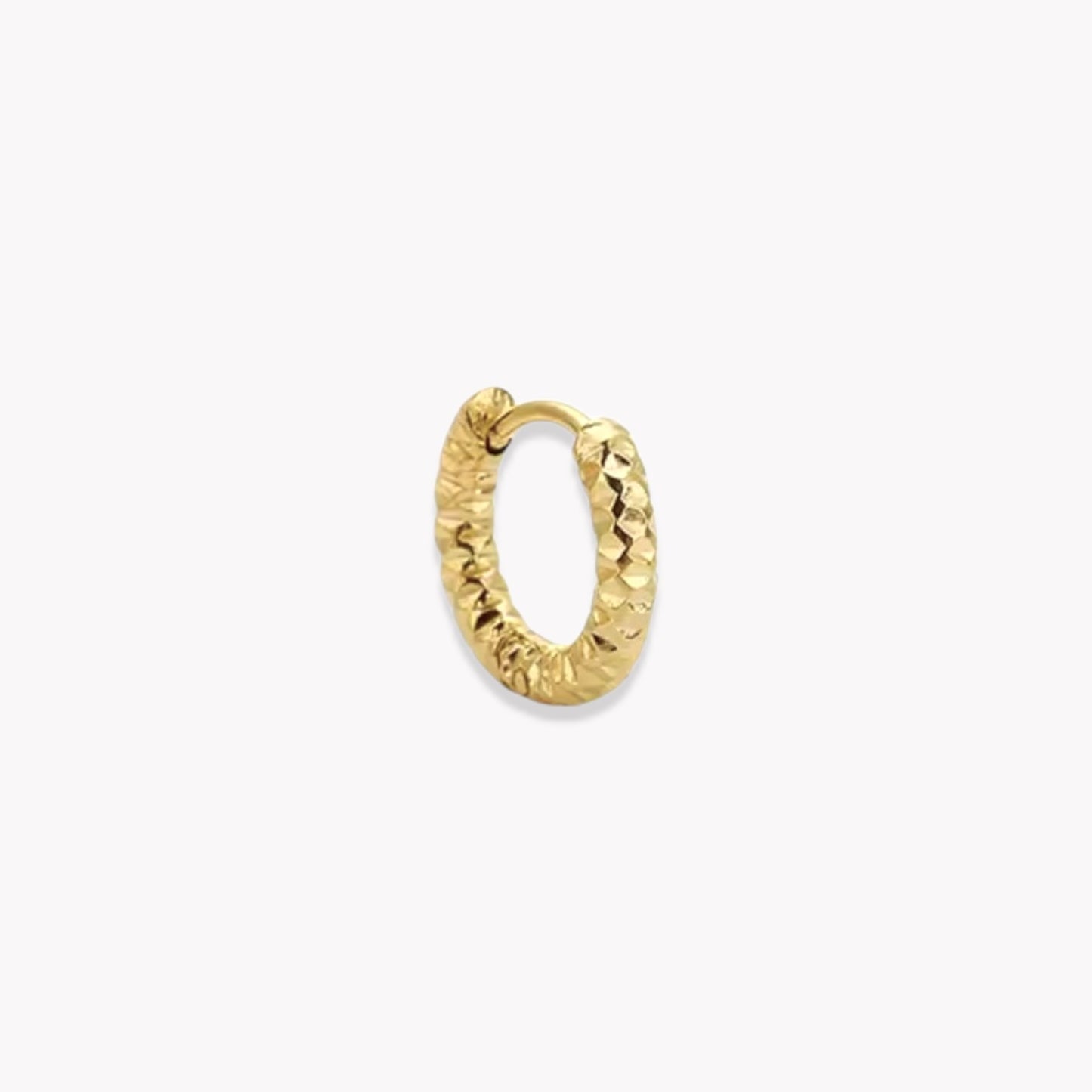 Gold hooped earring being shown in a closed position, pictured on a white background