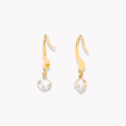 Gold earrings with clear gemstones on a white background