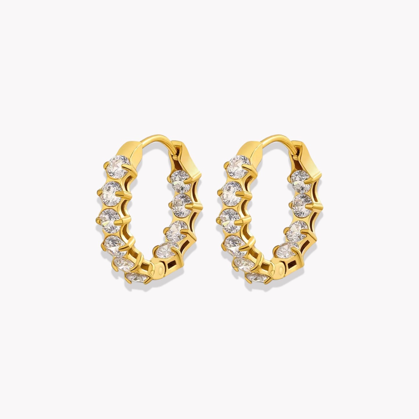 Gold hoop earrings with embedded diamonds on a white background