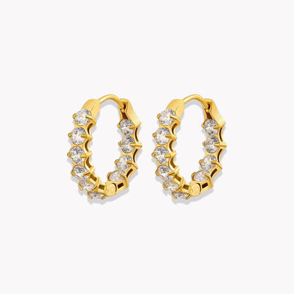 Gold hoop earrings with embedded diamonds on a white background